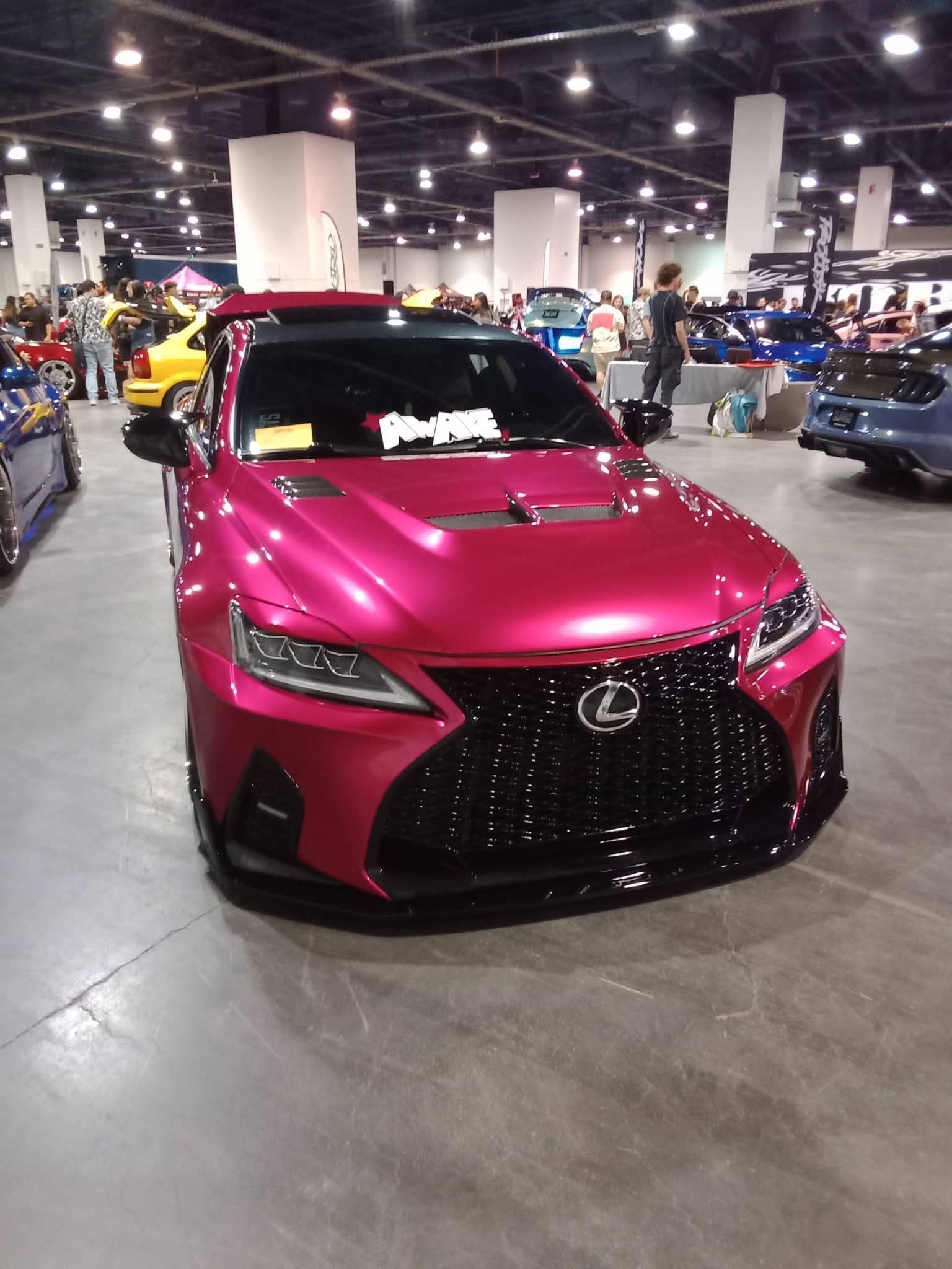 Pink Lexus at an indoor car show